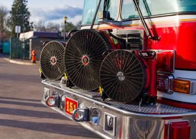 BlowHard's Squirt, Quickee, and Commando fans lined up in a row on the front bumper of a firetruck.