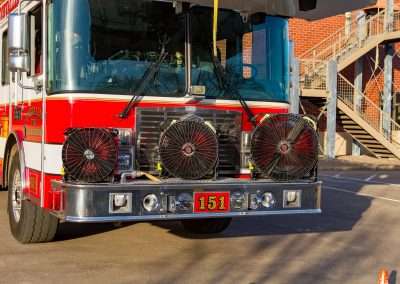 BlowHard's Squirt, Quickee, and Commando fans lined up in a row on the front bumper of a firetruck.